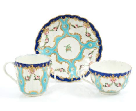 18th century Worcester fluted trio, circa 1772, with painted floral and fruit swags with turquoise, black and gilt borders.  