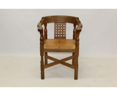 Robert 'Mouseman' Thompson of Kilburn, oak desk chair with bow back, raised on carved woven slats and close button leather se