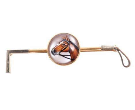 Stick pin in the form of a riding crop, with an Essex crystal cabochon painted with a horse's head, on mother of pearl ground