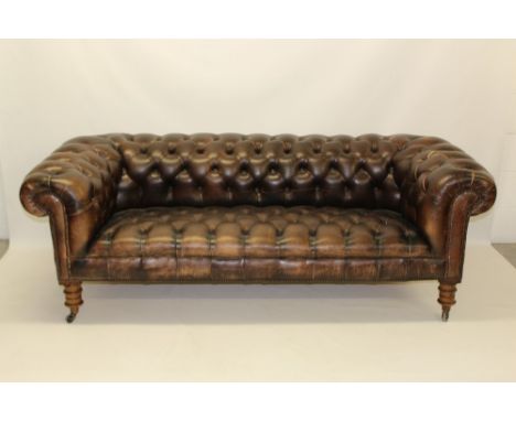 Good late 19th / early 20th century close stud and button leather upholstered Chesterfield sofa of typical form, raised on tu