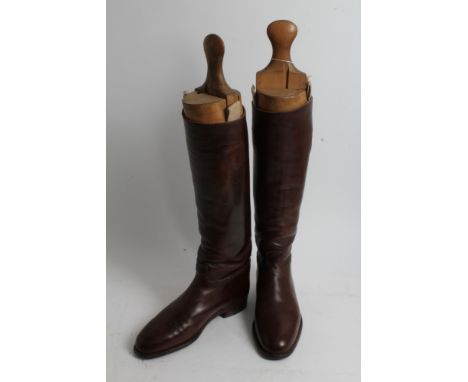 Pair of gentlemen's brown leather hunting boots with wooden trees, approximately size 10