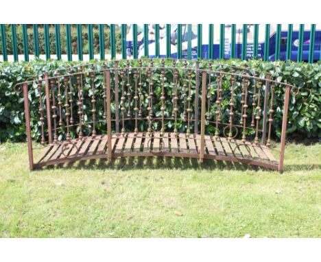 Impressive wrought iron 'Monet' bridge , the shallow arched bridge with scrolled handrail, raised on ornate spindle supports,