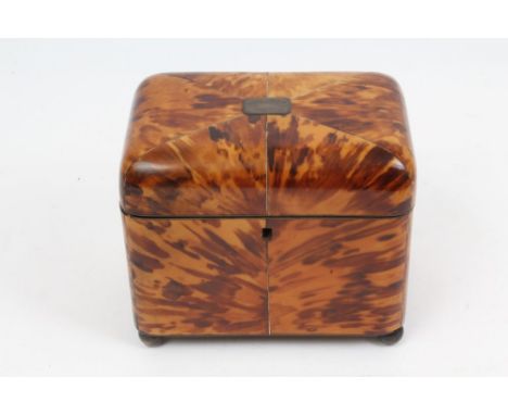 Good George III blond tortoiseshell and ebony line-inlaid tea caddy of cushion form, on silvered ball feet, the hinged cover 