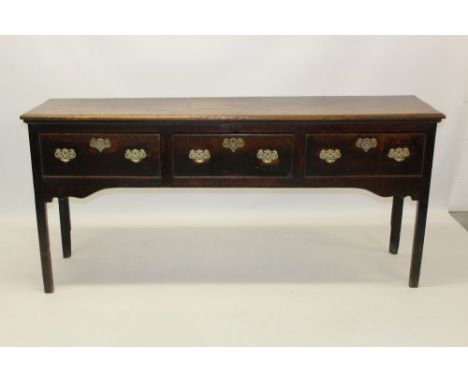 George III oak dresser base with moulded plank top and three drawers on chamfered supports, 180cm wide x 45cm deep x 83cm hig