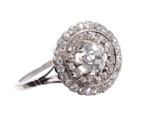 Edwardian-style diamond cluster ring with a central old cut diamond in claw setting, surrounded by a concentric border of old