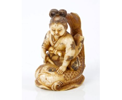 Late 19th century Japanese carved ivory netsuke of a girl slaying a large fish, signed, 5.6cm high CONDITION REPORT Good orig