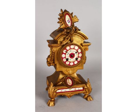 A 19TH CENTURY FRENCH GILT METAL MANTLE CLOCK with porcelain panels and dial. 14ins high.