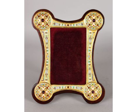 A RUSSIAN SILVER GILT AND ENAMEL SHAPED PHOTOGRAPH FRAME, set with enamels and cabochon stones. 23cms high, 18cms wide.