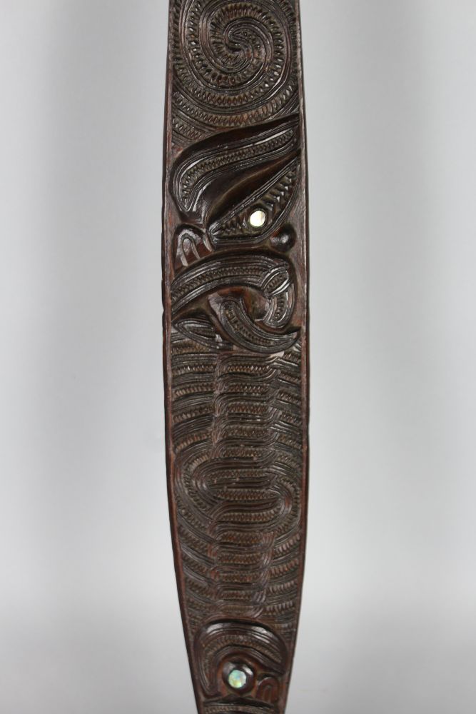 MAORI DANCE PADDLE Wood, paua shell, slender form with cylindrical ...