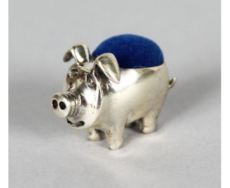 A MINIATURE SILVER PIG PIN CUSHION.