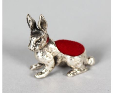 A MINIATURE SILVER RABBIT PIN CUSHION.