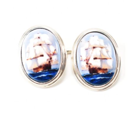 A pair of silver and enamel cufflinks. The cufflinks having enamel decorated heads depicting tall ship sailing boats marked 9