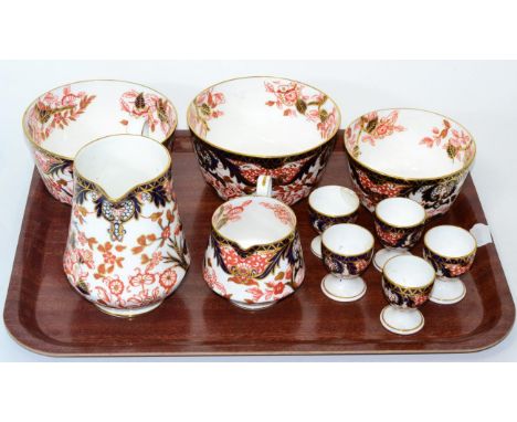 A pair of Royal Crown Derby Imari sugar bowls and a smaller example, two jugs and a set of five egg cups all in the same patt