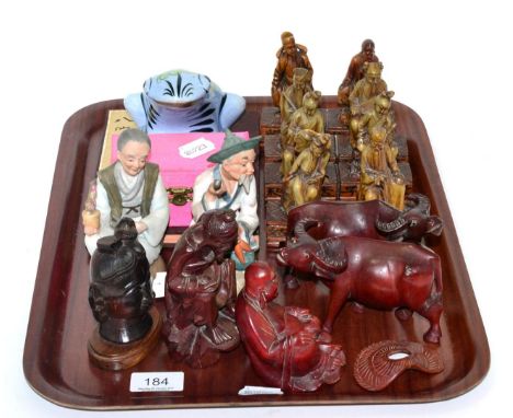 A set of eight carved soapstone figures of immortals, on wooden bases; together with various other carved wooden and ceramic 