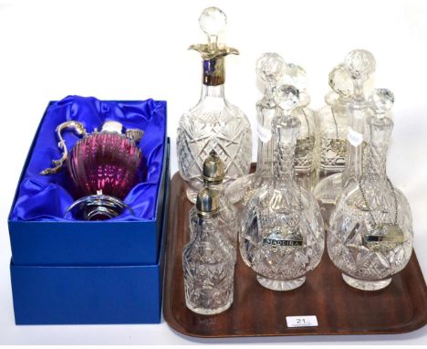 Three pairs of cut glass decanters with silver wine labels, a silver collared decanter, two silver topped oil bottles and a b