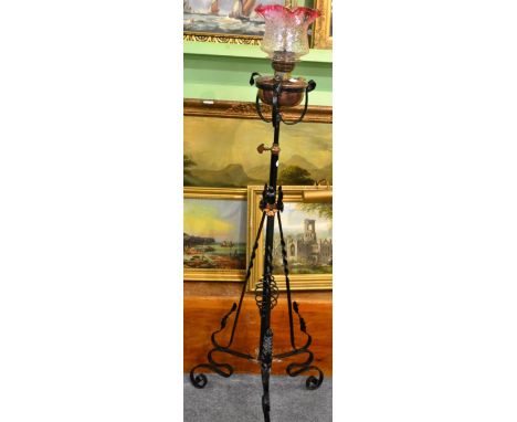 An Arts & Crafts wrought iron and copper standard lamp 