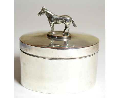 Equestrian Interest: A Silver Plated on Copper Box and Cover, early 20th century, of oval form with racehorse finial, the bas