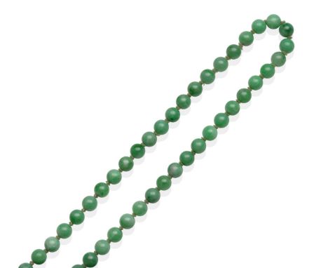 A Jade Necklace, a continuous strand of uniform jade beads, 66cm long see illustration  The necklace is in good condition. Th