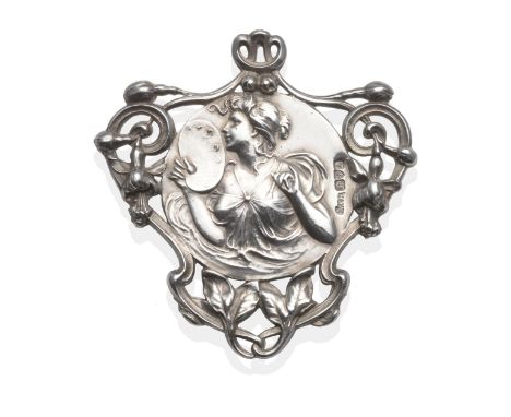 A Silver Art Nouveau Brooch, the central circular panel embossed with the allegorical figure of Art, within a scrolling folia