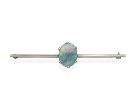 A Black Opal Bar Brooch, an oval cut opal in a white claw setting, to a knife edge bar, length 6.3cm see illustration  The br
