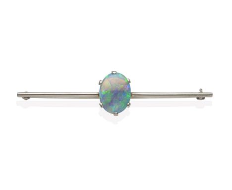 A Black Opal Bar Brooch, an oval cut opal in a white claw setting, to a knife edge bar, length 6.3cm see illustration  The br