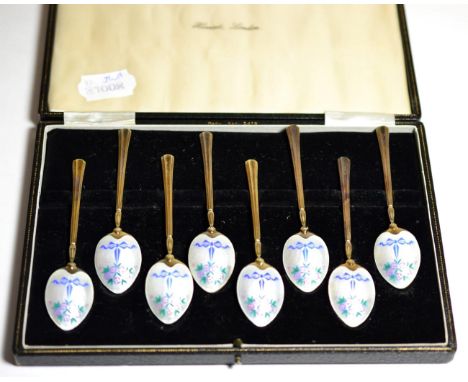 A Set of Eight Enamelled Silver Gilt Coffee Spoons, Birmingham 1956, decorated with ribbon tied flowers on an engine turned g