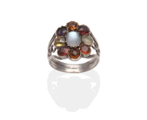 An Arts and Crafts Style Multi-Gemstone Ring, an oval moonstone within a border of round cut garnets, citrine, fluorite, fire