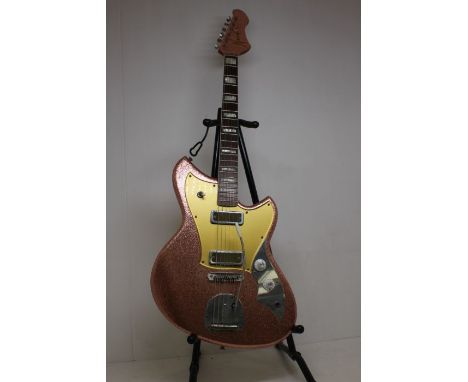 A Novo Serus J Electric Guitar In Burgundy Sparkle With Contour Body. Comes With Hard Body Carry CaseSpec:  Model Serus J    