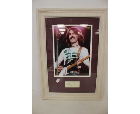 George Harrison Autographed piece of Paper framed with photo of George possibly 1980s era.