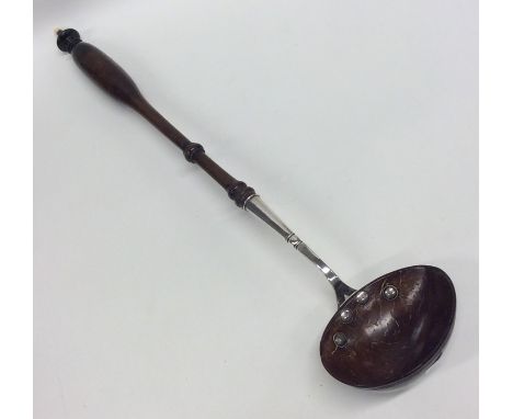 A silver and treen ladle with turned handle. Approx. 100 grams. Est. £100 - £150.