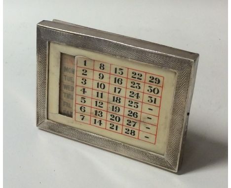 A silver mounted perpetual calendar in engine turned frame. Birmingham. Approx. 62 grams. Est. £20 - £30.
