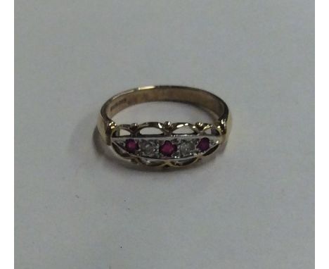 AN ornate ruby and diamond five stone ring in two colour gold. Approx. 2.3 grams. Est. £50 - £80.