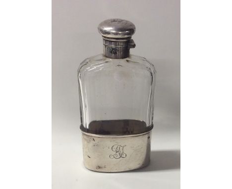 An Edwardian silver and glass flask. London. Est. £40 - £60.