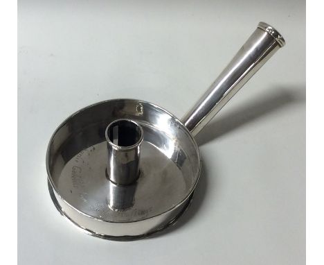 An unusual Georgian silver chamber stick of circular form with tapering handle. London. Approx. 144 grams. Est. £100 - £150.