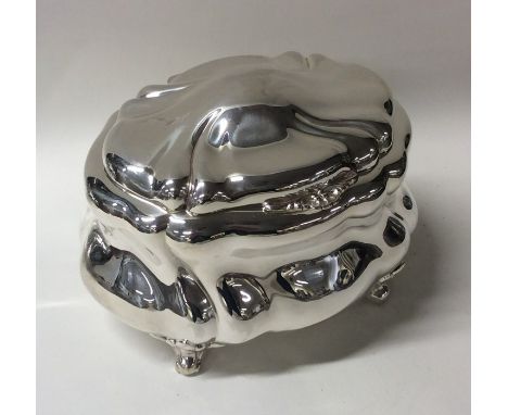 A Continental silver caddy of swirl form to scroll feet and domed lid. Approx. 268 grams. Est. £200 - £300.
