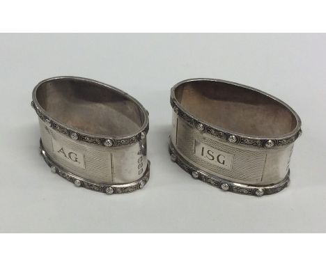 EDINBURGH: A pair of good quality engine turned silver napkin rings. Approx. 82 grams. Est. £35 - £45.