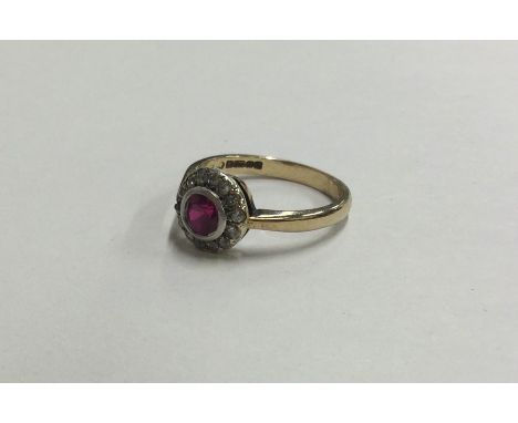 An Antique diamond and ruby ring of circular form in 9 carat mount. Approx. 2.6 grams. Est. £70 - £80.