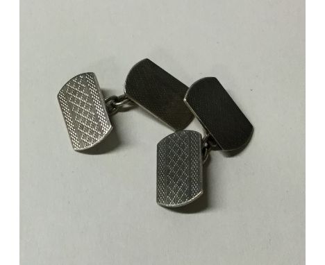 A pair of engine turned silver cufflinks. Approx. 7.5 grams. Est. £10 - £20.
