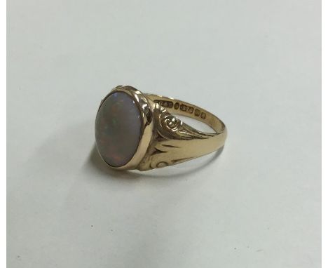 A gent's opal single stone signet ring in rubover 9 carat mount. Approx. 6.3 grams. Est. £120 - £150.