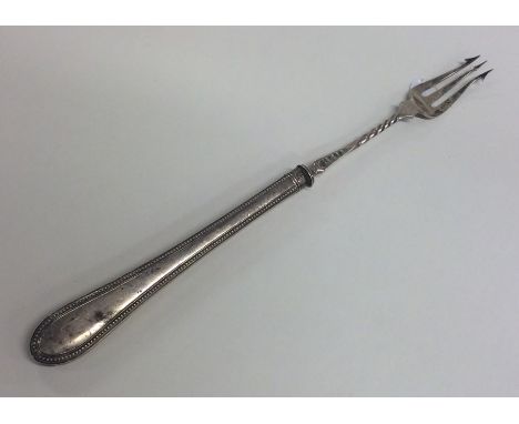 An Edwardian silver pickle fork with beaded rim. Est. £10 - £20.