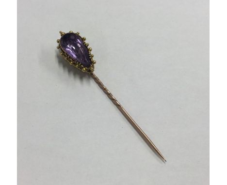 A high carat gold single stone amethyst stick pin. Approx. 5.1 grams. Est. £65 - £75.