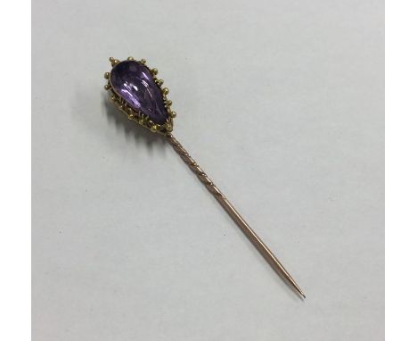 A high carat gold single stone amethyst stick pin. Approx. 5.1 grams. Est. £65 - £75.