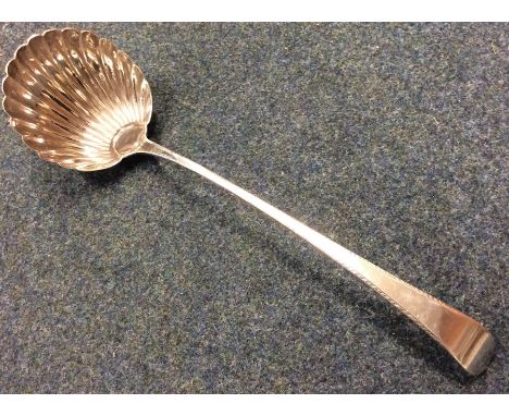 A large Georgian silver OE pattern ladle with fluted bowl. Approx. 140 grams. Est. £80 - £100.