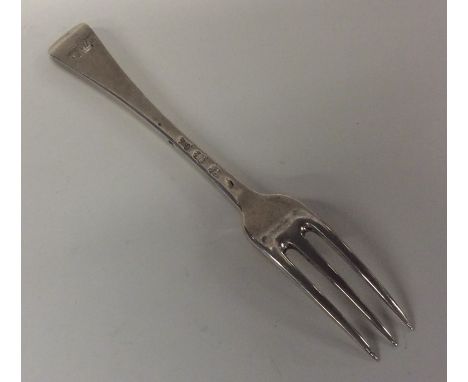 An early Georgian silver Hanoverian pattern three prong fork with crested terminal. Approx. 62 grams. Est. £50 - £80.