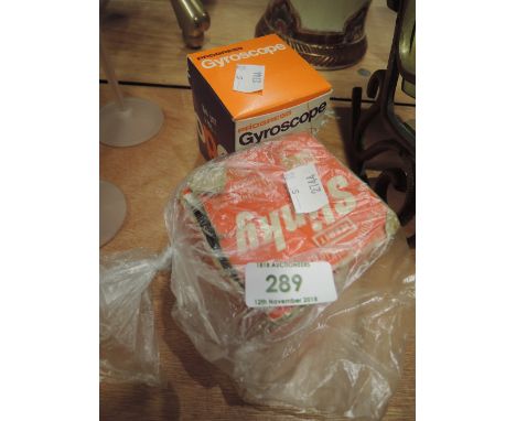 A vintage Gyroscope and a Slinky in its original box