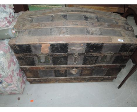 A vintage dome top travel trunk