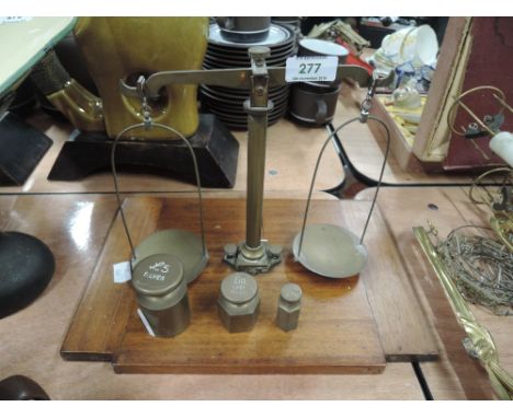 A vintage set of cash balance scales and weights on treen base