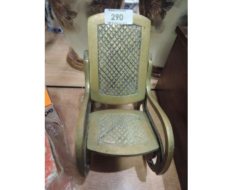 A vintage brass rocking chair