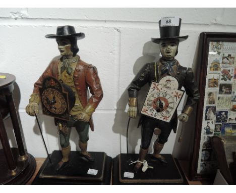 Two vintage reproduction cast clock peddler figure time piece clocks