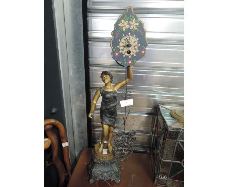A vintage Art Nouveau design lamp with figural lady and moving time piece 